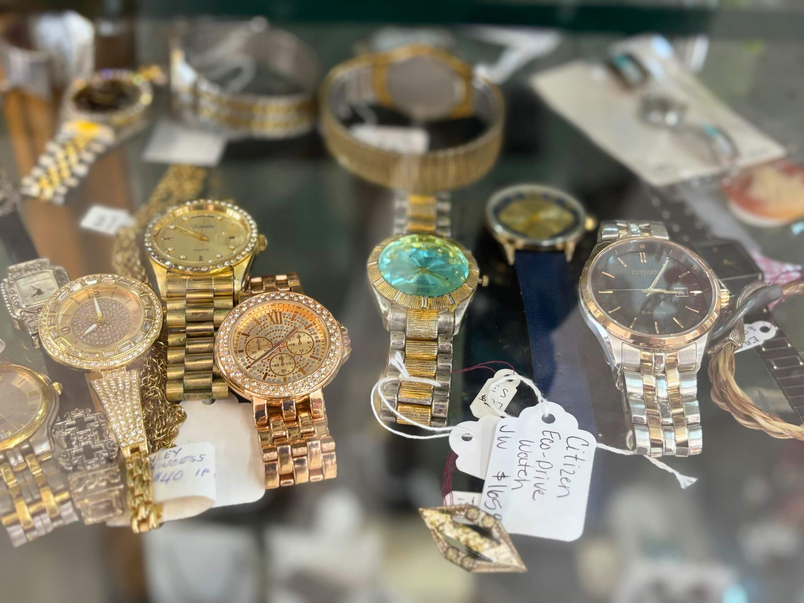 Collection of vintage and pre-owned watches including Citizen and gold-tone styles at Elmwood Antique Centre in Abilene, TX
