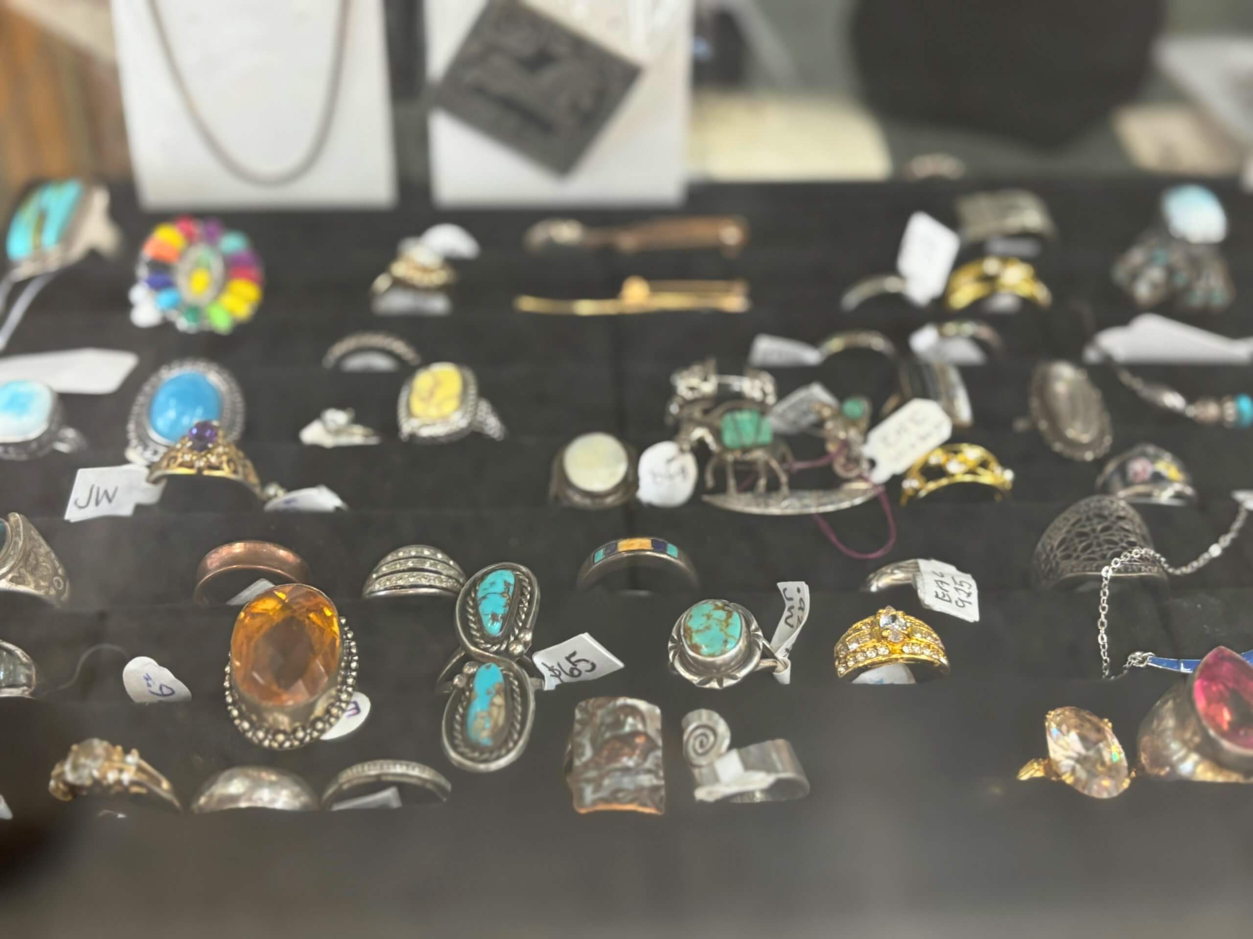 Assorted vintage rings and turquoise jewelry on display at Elmwood Antique Centre in Abilene, TX